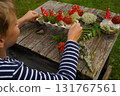 Eco-friendly autumn craft with natural and recycled elements, creating a mushroom figure. 131767561