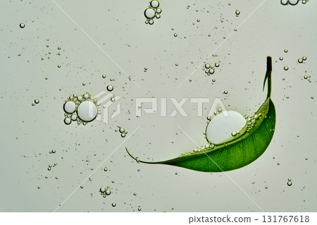 The texture of a green gel product with bubbles and a leaf. The texture of a green gel product with bubbles and a leaf. 131767618