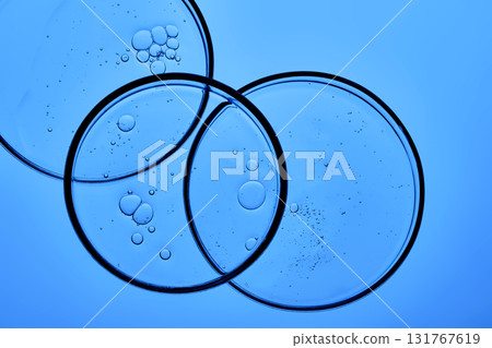Dish detergent in a petri dish on a blue background. Dish detergent in a petri dish on a blue background. 131767619