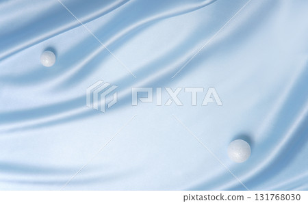 Smooth blue fabric with two white spheres like snowballs. Minimal festive background for Christmas, winter sale or product display. 131768030