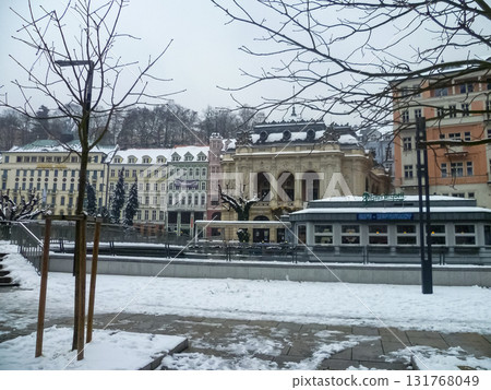 City streets, Baroque buildings, and a colonnade in winter. Snow creates a special atmosphere in the spa town. 131768049