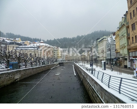 City streets, Baroque buildings, and a colonnade in winter. Snow creates a special atmosphere in the spa town. 131768053