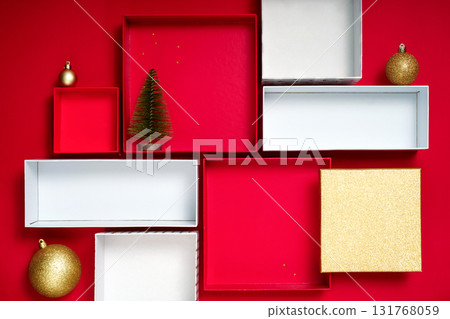 Festive holiday background with gift boxes, baubles and tree on red, perfect for sale banner or product showcase. Festive holiday background with gift boxes, baubles and tree on red, perfect for sale banner or product showcase. 131768059