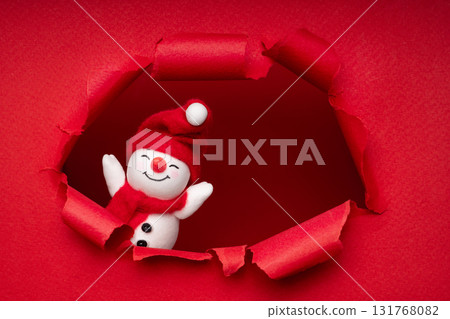 Creative Christmas background with torn paper hole and snowman. Ideal for banner, poster, flyer, social media and holiday sale. Creative Christmas background with torn paper hole and snowman. Ideal for banner, poster, flyer, social media and holiday sale. 131768082
