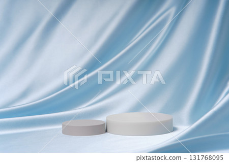 Elegant light blue satin folds with two cylinder podiums and wide copy space. Luxury background for product sets, comparisons and premium advertising. 131768095