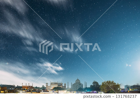 Taj Mahal In Agra, Uttar Pradesh, India. Night view Of Taj Mahal. Seven World Wonders. Night stars above Fabulous Taj Mahal Travel Concept. Indian Islamic Heritage At Night Time Taj Mahal In Agra, Uttar Pradesh, India. Night view Of Taj Mahal. Seven World Wonders. Night stars above Fabulous Taj Mahal Travel Concept. Indian Islamic Heritage At Night Time 131768237