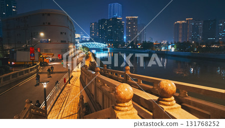 Night Payoff with Riverside Pathway and Vibrant Cityscape Reflections 131768252