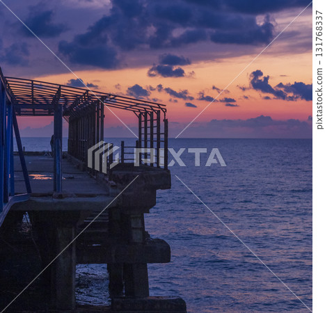 Abstract shot of the metal construction bars with cloudy sunset sky on the background 131768337