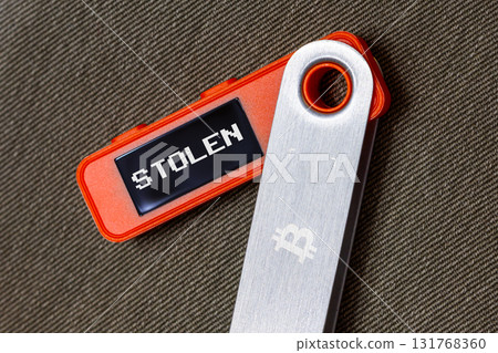 hardware Bitcoin wallet with message Stolen on screen 131768360