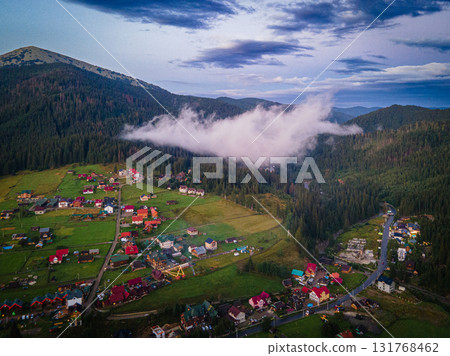 Mountainous countryside scenery at sunset. Dramatic sky above the distant valley. Green fields and trees on the hill. Beautiful nature scenery of carpathians. High quality photo Mountainous countryside scenery at sunset. Dramatic sky above the distant valley. Green fields and trees on the hill. Beautiful nature scenery of carpathians. High quality photo 131768462