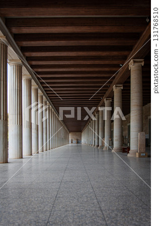 Building with many columns. A long passage between many old columns 131768510