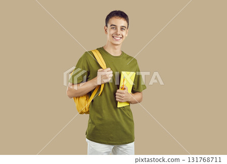 Portrait of happy, smiling college or high school student boy with backpack and notebook Portrait of happy, smiling college or high school student boy with backpack and notebook 131768711