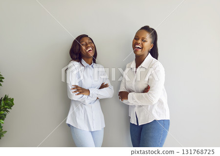 Smiling African American Women in Laughter on Grey Background 131768725