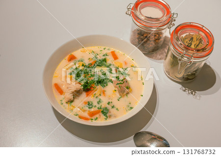 Traditional Belgian Waterzooi dish close-up, featuring creamy broth with fish, seafood, potatoes, and vegetables - a classic comfort food from Belgium. Traditional Belgian Waterzooi dish close-up, featuring creamy broth with fish, seafood, potatoes, and vegetables - a classic comfort food from Belgium. 131768732