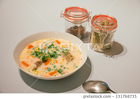 Traditional Belgian Waterzooi dish close-up, featuring creamy broth with fish, seafood, potatoes, and vegetables - a classic comfort food from Belgium. 131768735