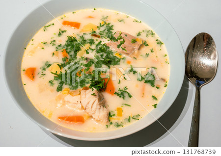 Traditional Belgian Waterzooi dish close-up, featuring creamy broth with fish, seafood, potatoes, and vegetables - a classic comfort food from Belgium. Traditional Belgian Waterzooi dish close-up, featuring creamy broth with fish, seafood, potatoes, and vegetables - a classic comfort food from Belgium. 131768739