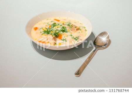 Traditional Belgian Waterzooi dish close-up, featuring creamy broth with fish, seafood, potatoes, and vegetables - a classic comfort food from Belgium. 131768744