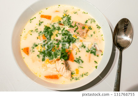 Traditional Belgian Waterzooi dish close-up, featuring creamy broth with fish, seafood, potatoes, and vegetables - a classic comfort food from Belgium. Traditional Belgian Waterzooi dish close-up, featuring creamy broth with fish, seafood, potatoes, and vegetables - a classic comfort food from Belgium. 131768755