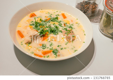 Traditional Belgian Waterzooi dish close-up, featuring creamy broth with fish, seafood, potatoes, and vegetables - a classic comfort food from Belgium. Traditional Belgian Waterzooi dish close-up, featuring creamy broth with fish, seafood, potatoes, and vegetables - a classic comfort food from Belgium. 131768785