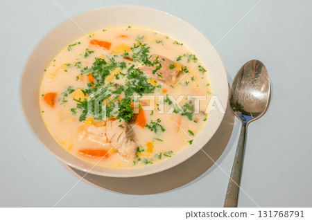 Traditional Belgian Waterzooi dish close-up, featuring creamy broth with fish, seafood, potatoes, and vegetables - a classic comfort food from Belgium. Traditional Belgian Waterzooi dish close-up, featuring creamy broth with fish, seafood, potatoes, and vegetables - a classic comfort food from Belgium. 131768791