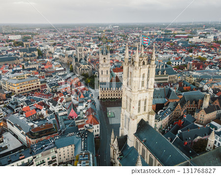 Cinematic drone shot focusing on Ghents Belfry tower and surrounding old town streets. 131768827