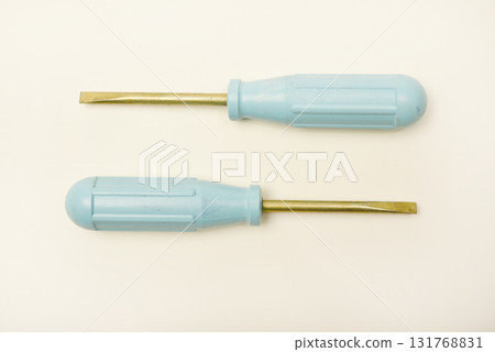 A light blue phillips screwdriver on a white background. A hand tool. 131768831