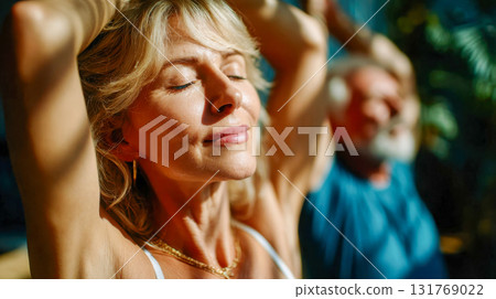 Senior woman practicing yoga with calm focus in warm sunlight during a fitness session 131769022