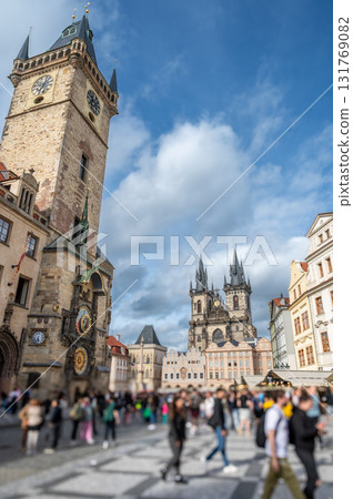 Prague,Czech Republic,August 7,2023.Iconic shot of the busy Old Town Square.Summer day,with the astronomical clock tower on the left and the Church of Our Lady before Tyn on the right. Vertical format 131769082