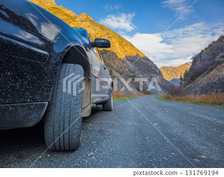 Car parked on dirt road in mountainous region during daytime Car parked on dirt road in mountainous region during daytime 131769194