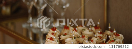 Banner Mini canape appetizers with cream and red caviar on glass tray. Banner Mini canape appetizers with cream and red caviar on glass tray. 131769212