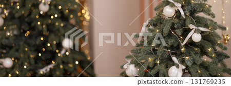Banner christmas trees with white baubles and lights in room with beige wall Banner christmas trees with white baubles and lights in room with beige wall 131769235