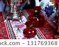 Red decorative vase in the shape of a pomegranate. Wedding table d cor. Gold and white 131769368