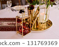 Red decorative vase in the shape of a pomegranate. Wedding table d cor. Gold and white 131769369