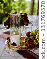 Red decorative vase in the shape of a pomegranate. Wedding table d cor. Gold and white 131769370