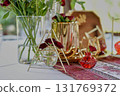 Red decorative vase in the shape of a pomegranate. Wedding table d cor. Gold and white 131769372
