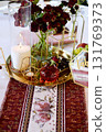 Red decorative vase in the shape of a pomegranate. Wedding table d cor. Gold and white 131769373