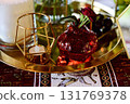 Red decorative vase in the shape of a pomegranate. Wedding table d cor. Gold and white 131769378