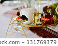 Red decorative vase in the shape of a pomegranate. Wedding table d cor. Gold and white 131769379