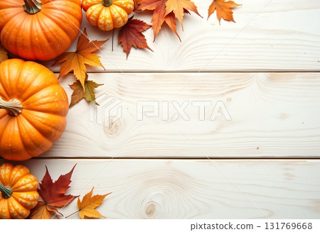 Pumpkin motif with autumn foliage on a wooden background 131769668