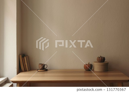 Autumn interior still life. Scandinavian living room, home office. Pumpkins, books, gift box, coffee cup on table. Fall, Halloween or Thanksgiving holiday home decor. Empty beige wall mockup 131770367
