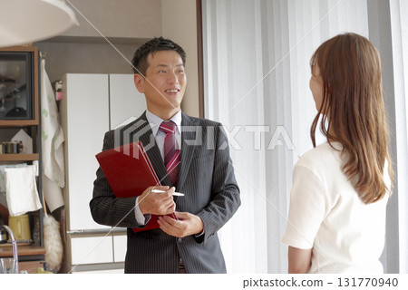 Sales staff and a woman explaining a model house Sales staff and a woman explaining a model house 131770940