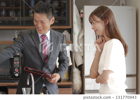 Sales staff and a woman explaining a model house 131770943