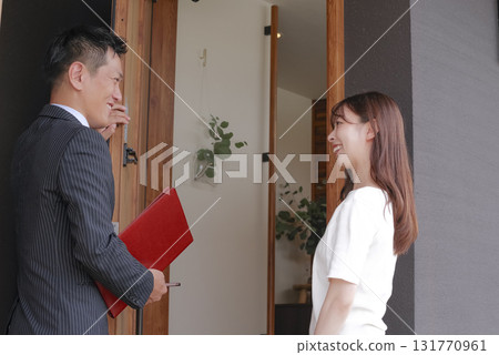 Sales staff and a woman showing a model house Sales staff and a woman showing a model house 131770961