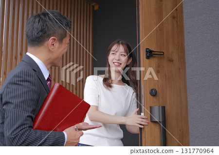 Sales staff and a woman showing a model house Sales staff and a woman showing a model house 131770964