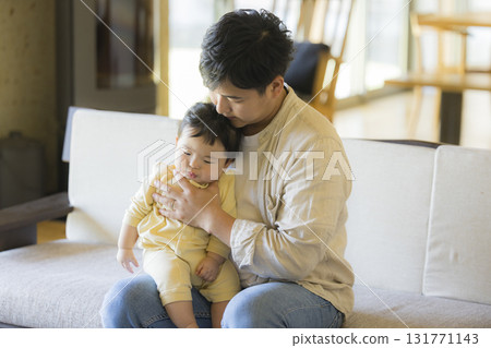 Dad holding a baby 131771143