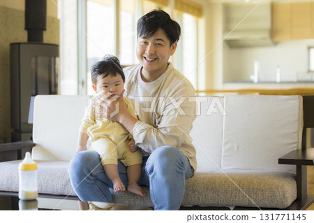 Dad holding a baby 131771145