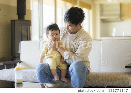 Dad holding a baby Dad holding a baby 131771147