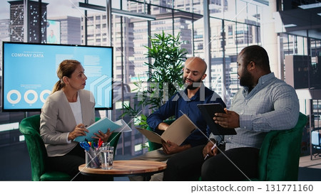 Corporate leadership team in a business meeting use data driven analysis and strategic thinking to identify insights and guide executive decisions across a global company. Camera A. Corporate leadership team in a business meeting use data driven analysis and strategic thinking to identify insights and guide executive decisions across a global company. Camera A. 131771160
