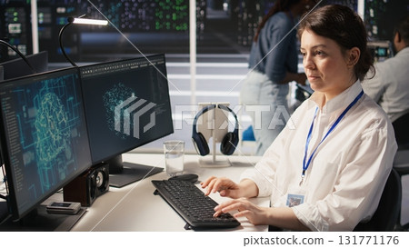 Data center technician monitors server rigs performing AI training and inference tasks. Server hub IT professional oversees high tech systems managing deep learning storage operations, camera A 131771176