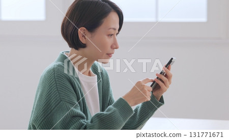 A woman watching a smartphone 131771671